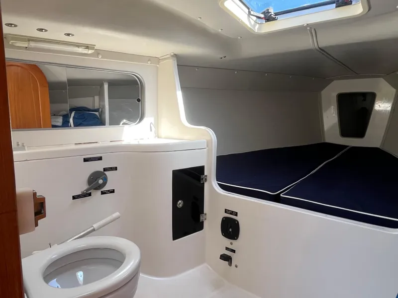 Slide: The Image of 2005 J Boats J/100 interior with compact bathroom and cozy sleeping area. - 11