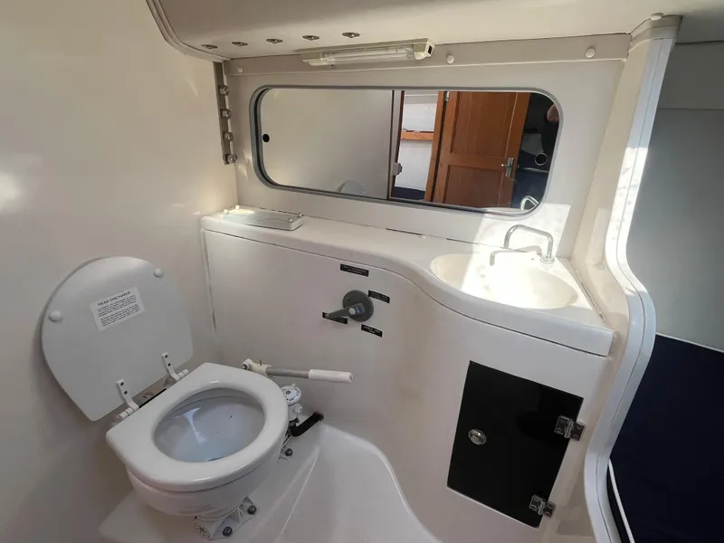 Slide: The Image of 2005 J Boats J/100 yacht bathroom with toilet, sink, and mirror. - 12