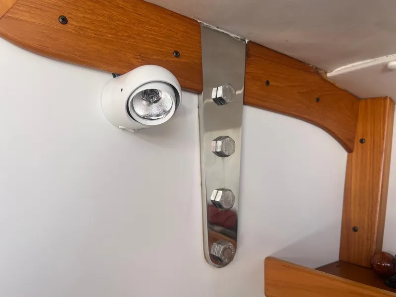 Slide: The Image of Interior detail of a 2005 J Boats J/100, featuring a mounted light and wooden trim. - 14