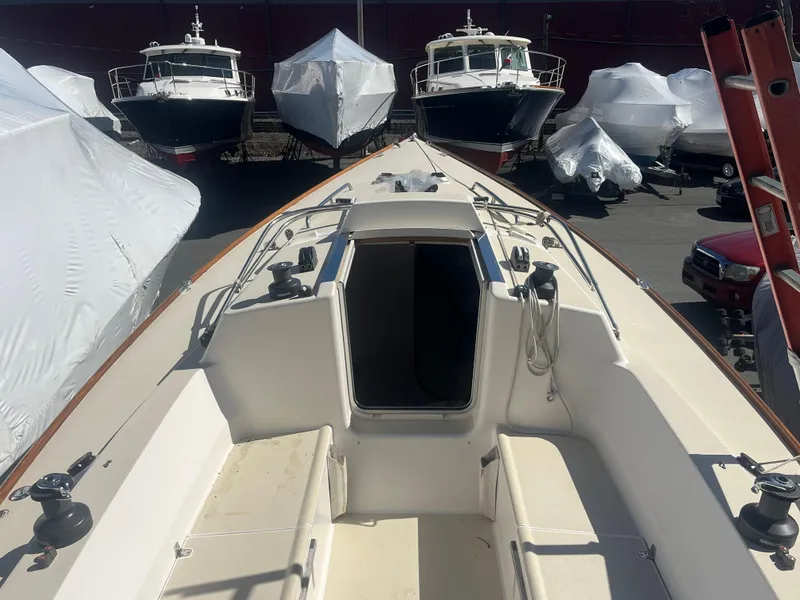 Slide: The Image of 2005 J Boats J/100 sailboat in storage, surrounded by covered vessels. - 15