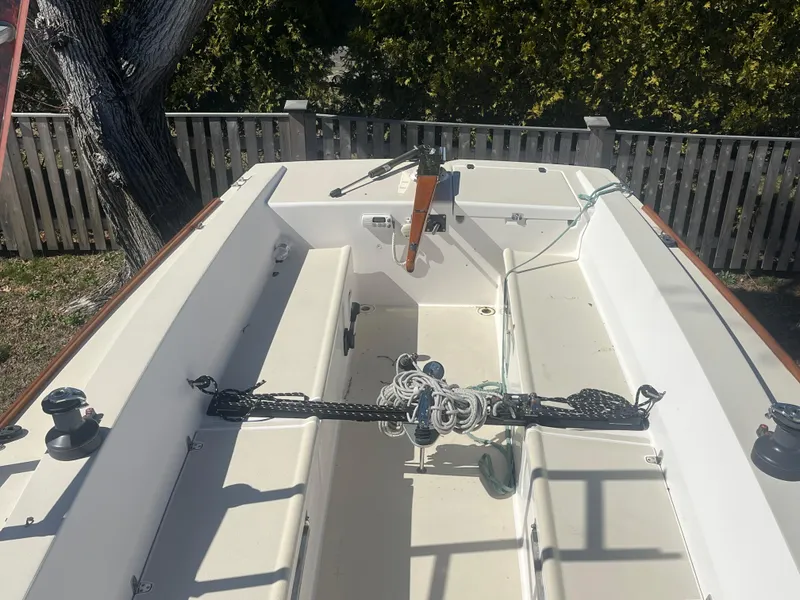 Slide: The Image of 2005 J Boats J/100 sailboat cockpit with ropes and winches, surrounded by wooden fence. - 16