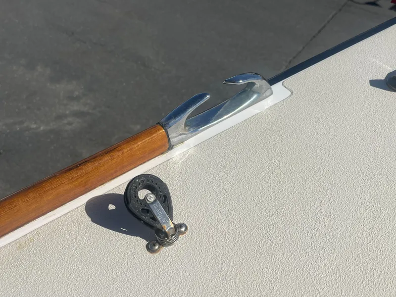 Slide: The Image of Boat deck with a wooden-handled hook and pulley on a 2005 J Boats J/100. - 23