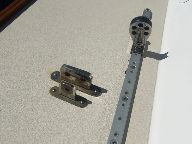Slide: The Image of Deck fittings on a 2005 J Boats J/100 sailboat, featuring metal hardware components. - 24