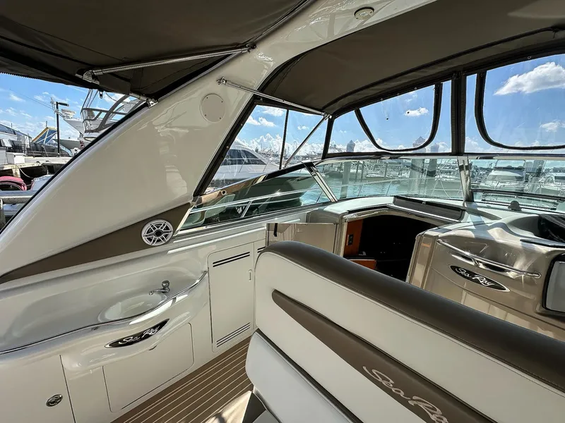 Slide: The Image of Interior view of 1999 Sea Ray 400 Sundancer yacht, featuring helm and seating area. - 14