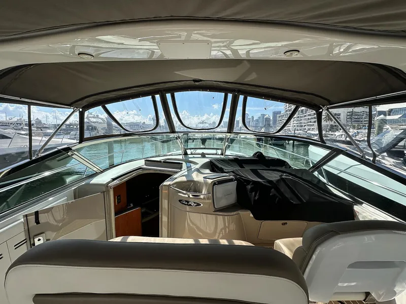 Slide: The Image of Interior view of 1999 Sea Ray 400 Sundancer yacht with panoramic windows and seating. - 16