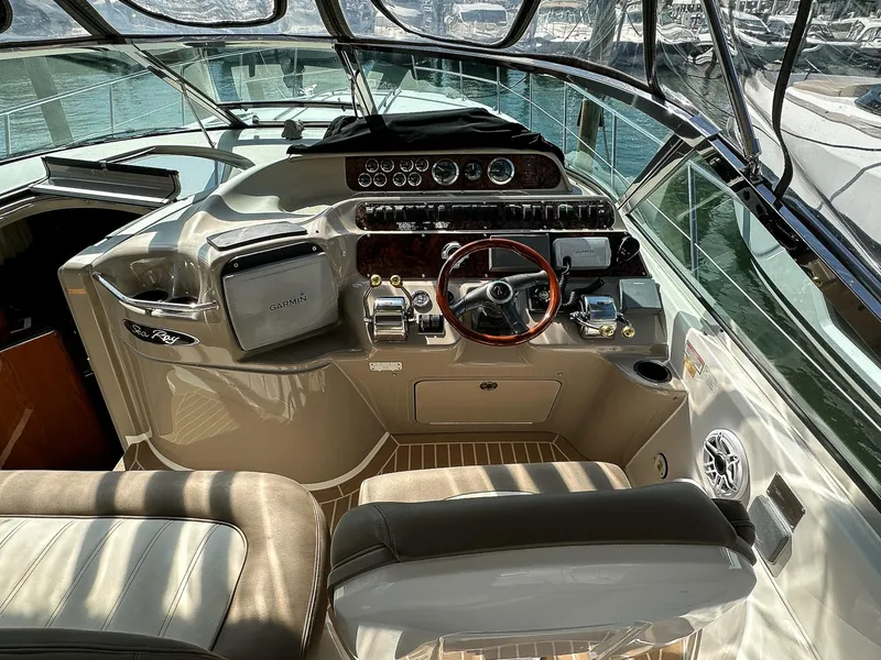 Slide: The Image of 1999 Sea Ray 400 Sundancer helm with Garmin navigation, wood steering wheel, and modern controls. - 17