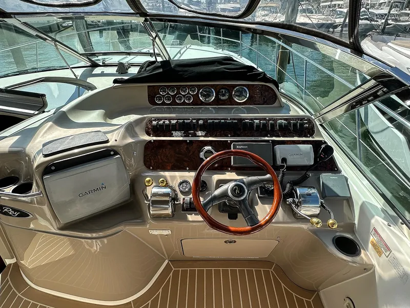 Slide: The Image of Cockpit of 1999 Sea Ray 400 Sundancer with Garmin navigation system and wooden steering wheel. - 18