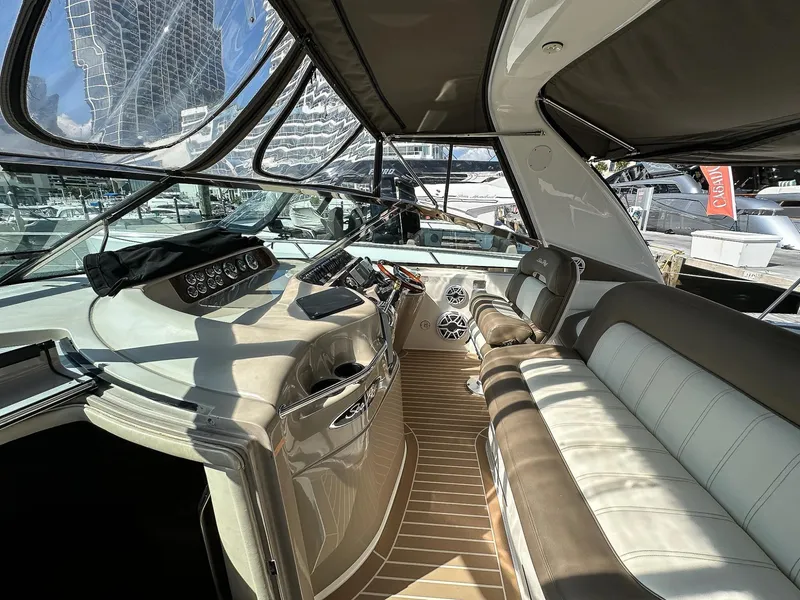Slide: The Image of 1999 Sea Ray 400 Sundancer yacht interior with modern helm and seating. - 21