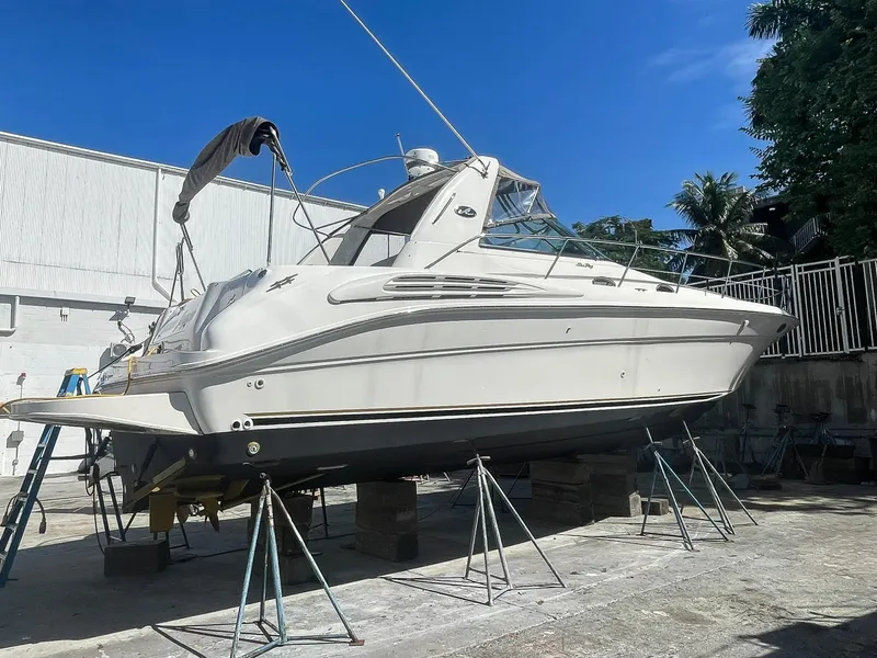 Slide: The Image of 1999 Sea Ray 400 Sundancer yacht on dry dock under clear blue sky. - 26