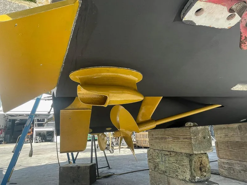Slide: The Image of 1999 Sea Ray 400 Sundancer propeller and rudder in dry dock maintenance. - 34