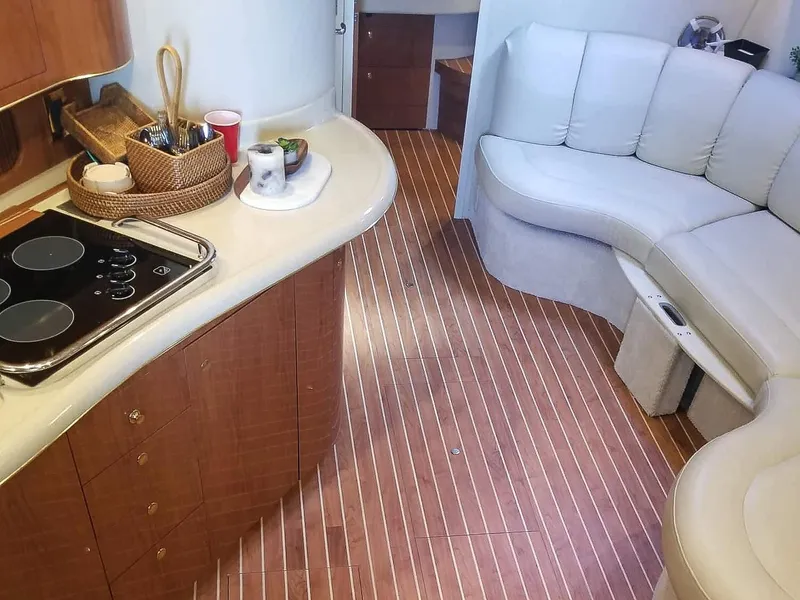 Slide: The Image of Interior of 1999 Sea Ray 400 Sundancer yacht with kitchen and seating area. - 35