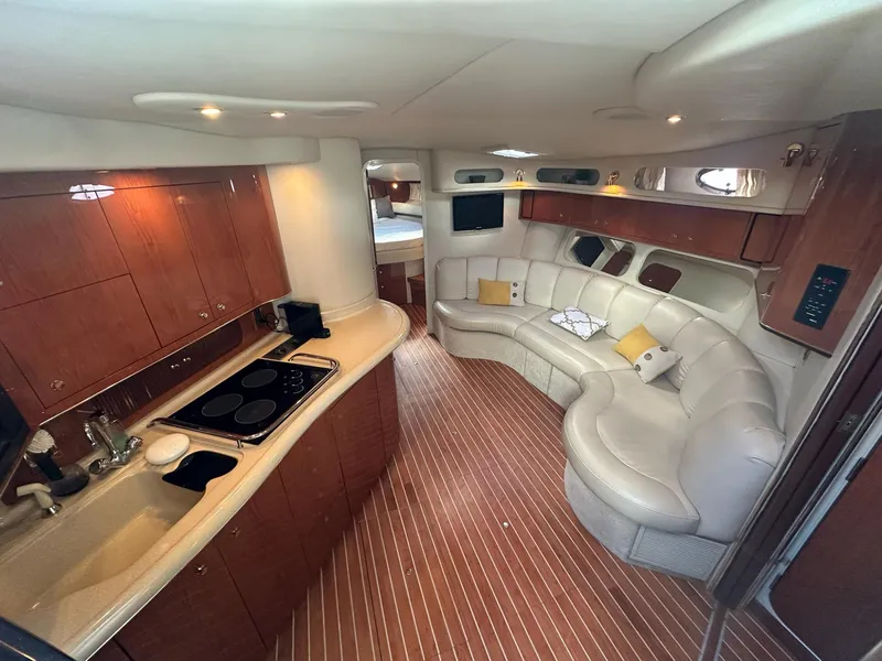 Slide: The Image of Luxurious interior of 1999 Sea Ray 400 Sundancer yacht with kitchen and seating area. - 37
