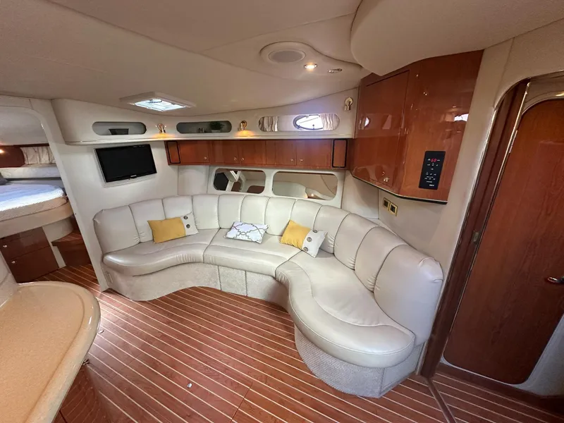 Slide: The Image of Luxurious interior of 1999 Sea Ray 400 Sundancer yacht with plush seating and wood accents. - 39