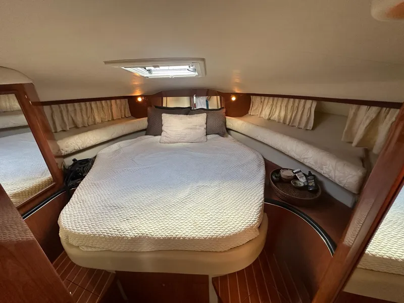 Slide: The Image of 1999 Sea Ray 400 Sundancer cabin with cozy bed and elegant wood finish. - 40