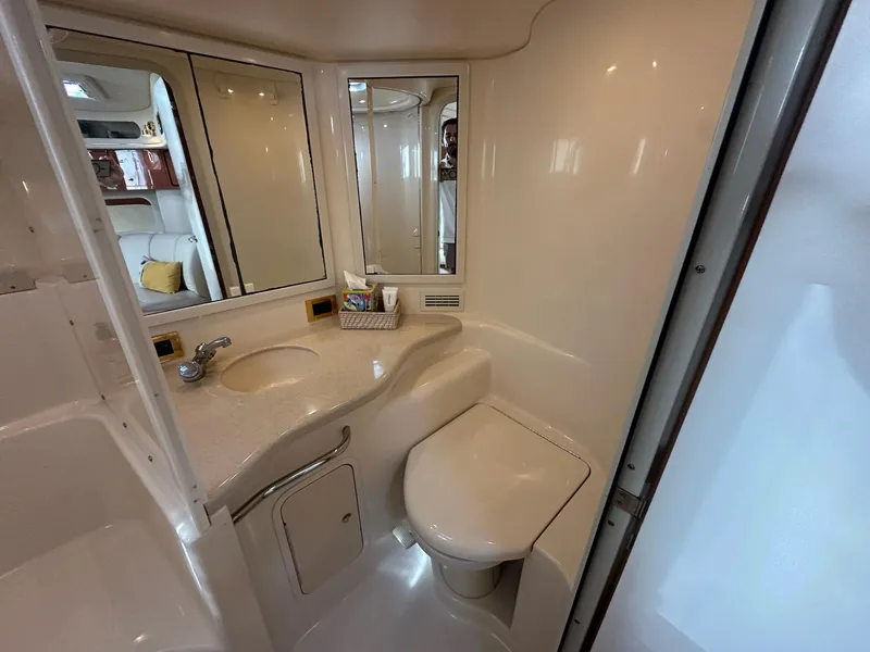 Slide: The Image of Bathroom interior of 1999 Sea Ray 400 Sundancer yacht, featuring sink and toilet. - 44
