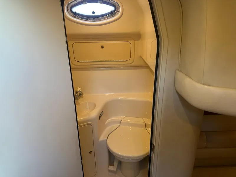 Slide: The Image of 1999 Sea Ray 400 Sundancer bathroom with compact design and porthole window. - 47