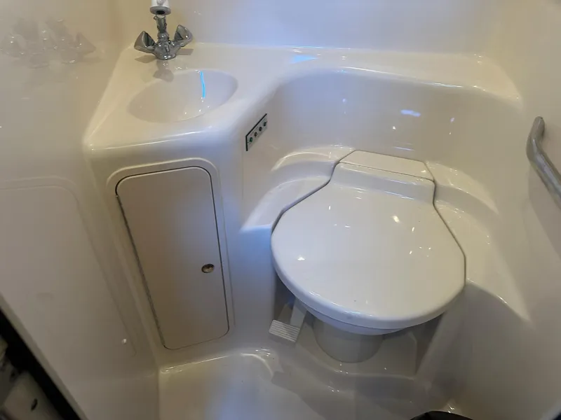 Slide: The Image of Bathroom interior of 1999 Sea Ray 400 Sundancer yacht, featuring sink and toilet. - 48