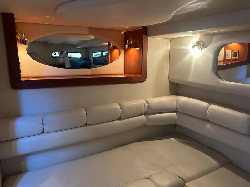 Slide: The Image of Interior of 1999 Sea Ray 400 Sundancer yacht with plush seating and elegant lighting. - 49