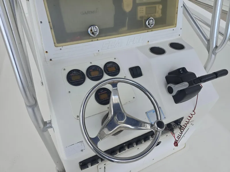 Slide: The Image of 2005 Sea Pro 270 Center Console helm with steering wheel and gauges. - 10