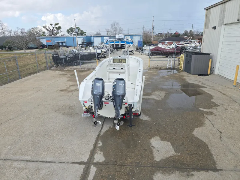 Slide: The Image of 2005 Sea Pro 270 Center Console boat with dual outboard motors in a parking lot. - 15