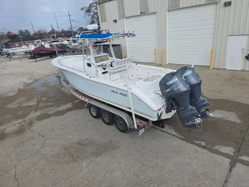 Slide: The Image of 2005 Sea Pro 270 Center Console boat with dual Yamaha engines on a trailer. - 16