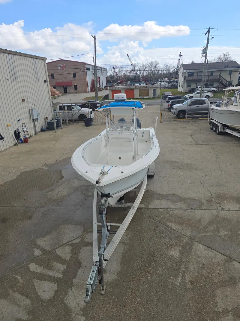 Slide: The Image of 2005 Sea Pro 270 Center Console boat on trailer in a parking lot. - 2
