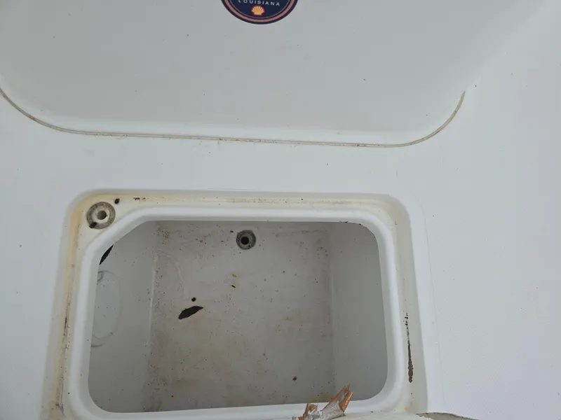 Slide: The Image of Open storage compartment on a 2005 Sea Pro 270 Center Console boat. - 5