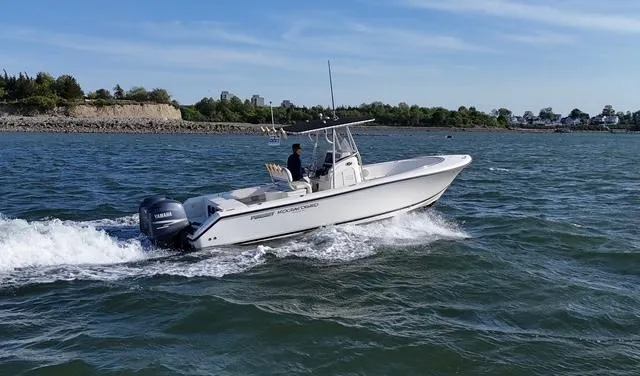 Slide: The Image of 2005 Pursuit 2570 Center Console boat cruising on open water. - 1