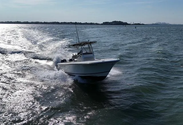 Slide: The Image of 2005 Pursuit 2570 Center Console boat cruising on open water under clear skies. - 11