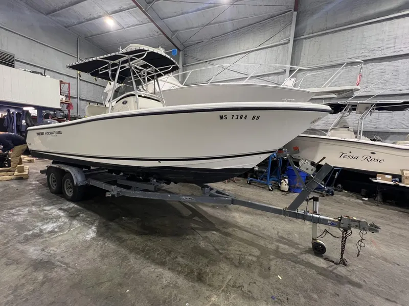 Slide: The Image of 2005 Pursuit 2570 Center Console boat on trailer in indoor storage. - 25
