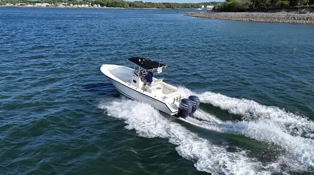 Slide: The Image of 2005 Pursuit 2570 Center Console boat cruising on open water. - 3