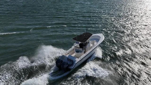 Slide: The Image of 2005 Pursuit 2570 Center Console boat cruising on open water. - 9