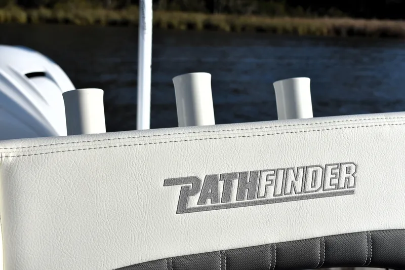 Slide: The Image of 2024 Pathfinder 2700 Open boat seat with logo, featuring rod holders. - 12