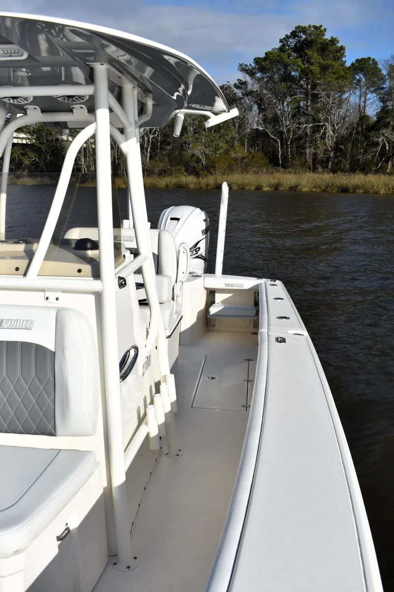 Slide: The Image of 2024 Pathfinder 2700 Open boat on a calm river, featuring sleek design and modern amenities. - 15