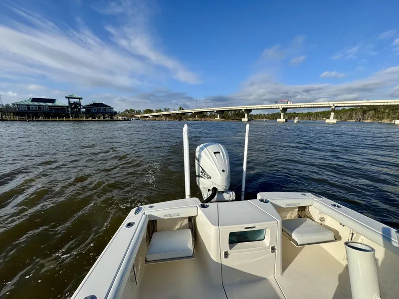 Slide: The Image of 2024 Pathfinder 2700 Open boat on a scenic waterway with bridge and buildings. - 19