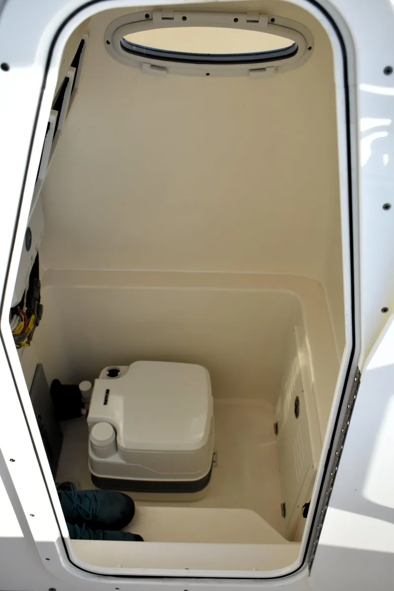 Slide: The Image of 2024 Pathfinder 2700 Open boat interior with compact toilet. - 22