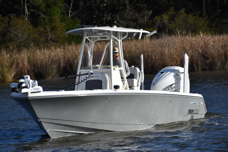 Slide: The Image of 2024 Pathfinder 2700 Open boat cruising on a calm waterway. - 6