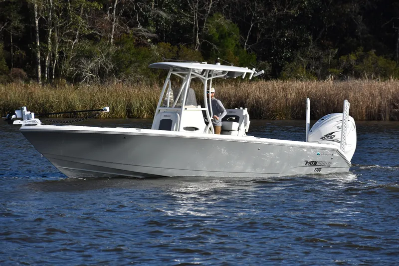 Slide: The Image of 2024 Pathfinder 2700 Open boat cruising on a calm river with lush greenery. - 7