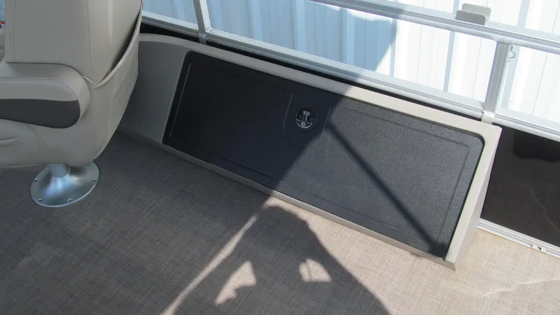 Slide: The Image of 2023 Sun Tracker SportFish 22 DLX interior with storage compartment and seating. - 10