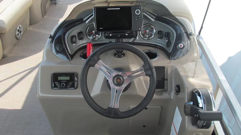 Slide: The Image of 2023 Sun Tracker SportFish 22 DLX dashboard with steering wheel and control panel. - 12
