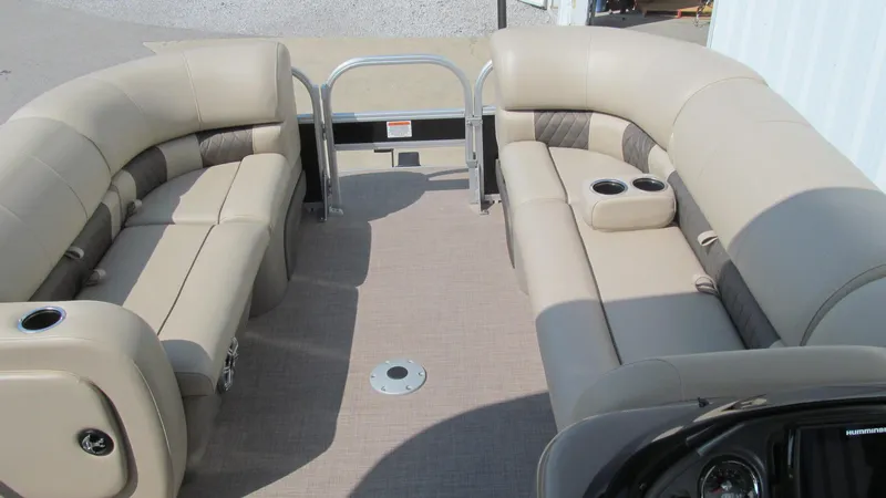 Slide: The Image of 2023 Sun Tracker SportFish 22 DLX pontoon boat interior with beige seating and cup holders. - 15
