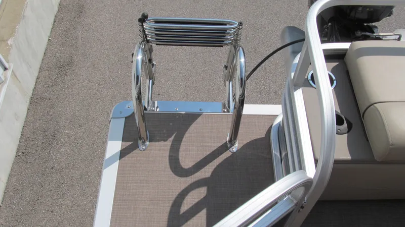 Slide: The Image of 2023 Sun Tracker SportFish 22 DLX boat ladder and seating area, showcasing sleek design and functionality. - 16