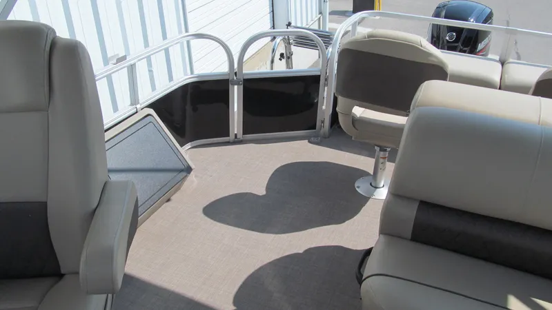 Slide: The Image of 2023 Sun Tracker SportFish 22 DLX interior with beige seating and spacious deck layout. - 6