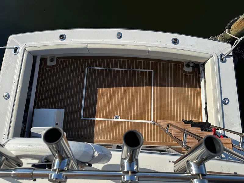 Slide: The Image of 1989 Tiara Yachts 3100 Convertible deck with wood finish and fishing rod holders. - 8