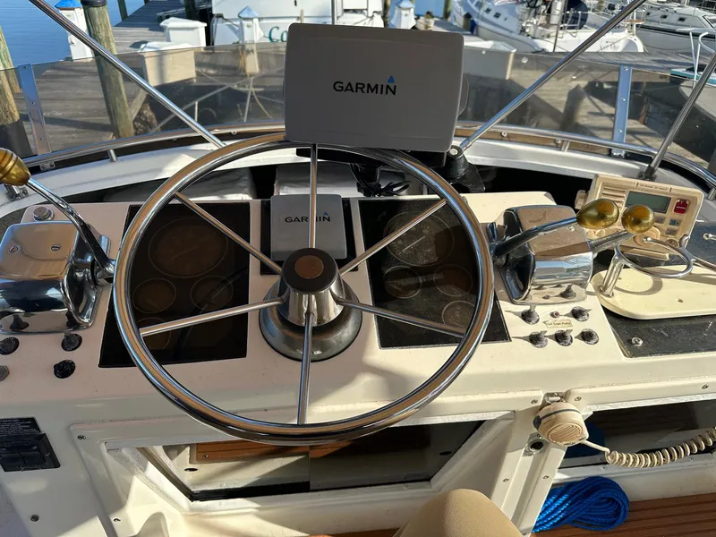 Slide: The Image of 1989 Tiara Yachts 3100 Convertible helm with Garmin navigation system and steering wheel. - 9