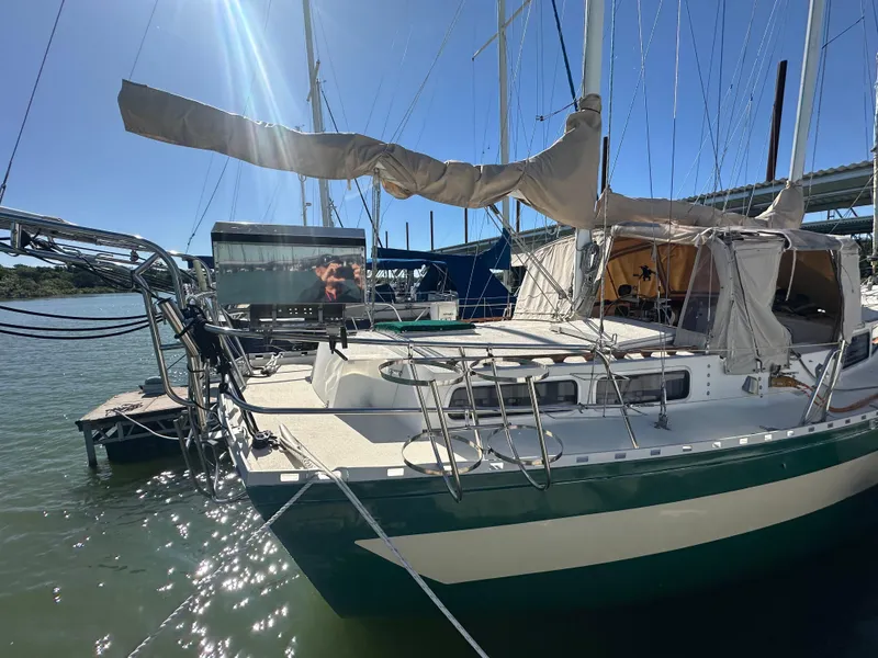 Slide: The Image of 1981 Islander Freeport Ketch sailboat docked in sunny marina. - 10