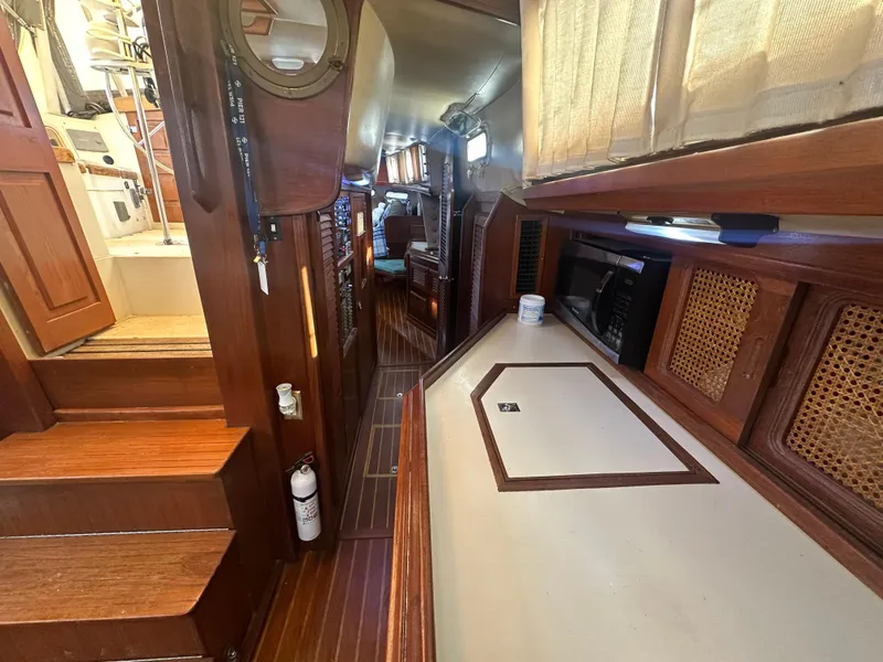 Slide: The Image of Interior of 1981 Islander Freeport Ketch sailboat with wood finishes and compact layout. - 43