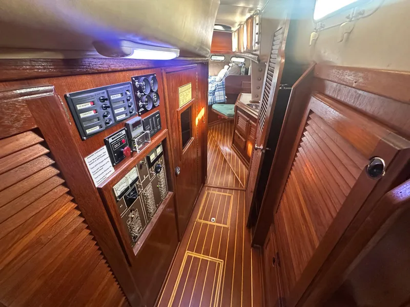 Slide: The Image of 1981 Islander Freeport Ketch interior with wood paneling and control panels. - 45