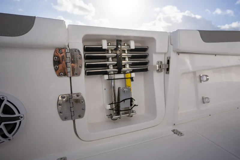 Slide: The Image of 2025 Caymas 291 boat compartment with mechanical components and hinges, under a bright sky. - 5