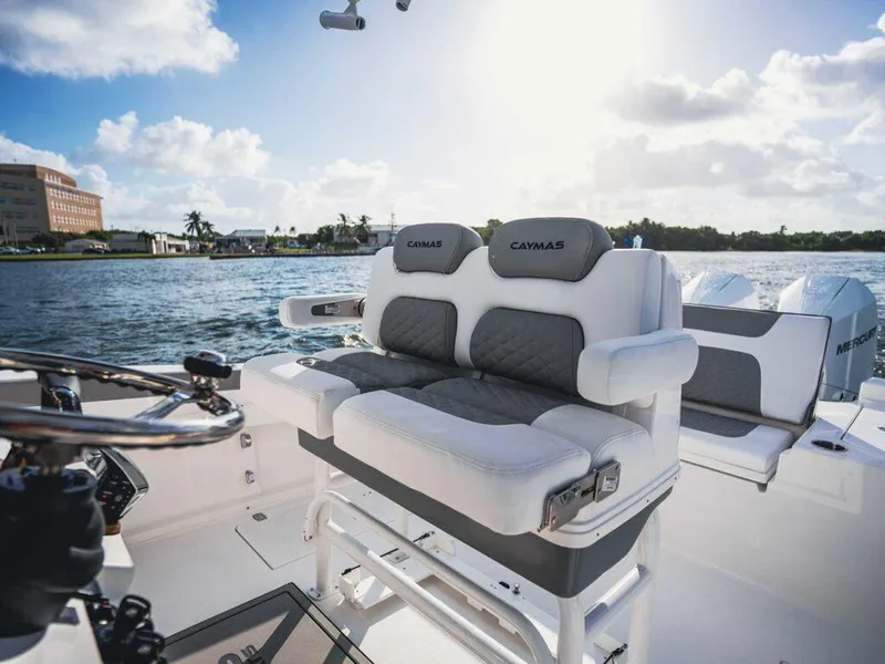 Slide: The Image of 2025 Caymas 291 boat interior with plush seating, overlooking serene water and clear sky. - 9